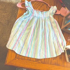 A dressier tank with vibrant spring colored stripes in different sizes.